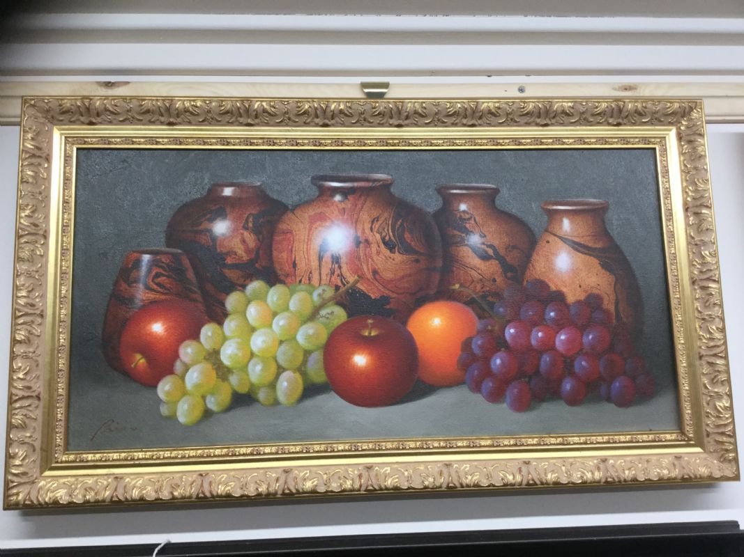 A still life of pottery and fruit indistinctly signed 
