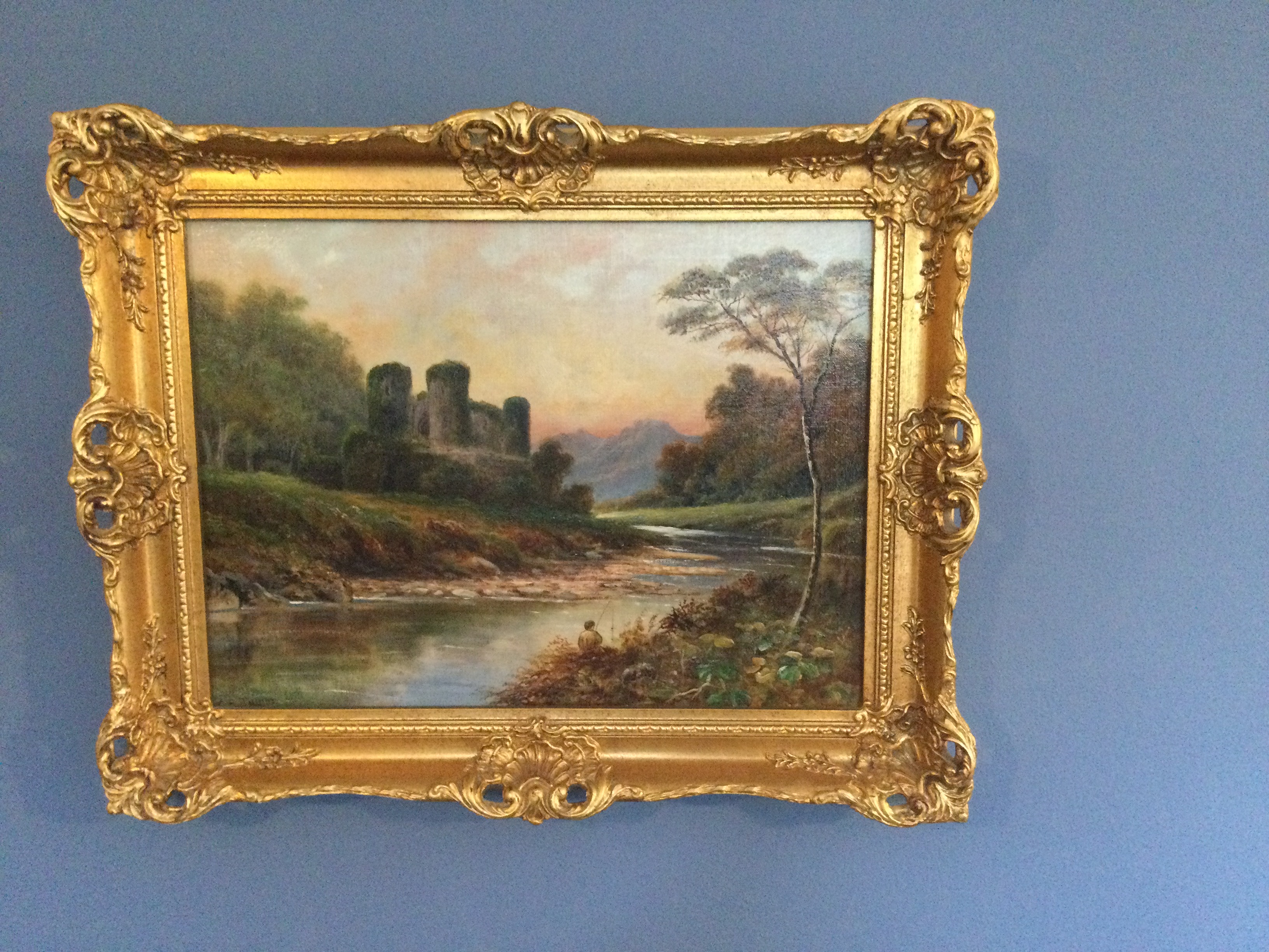 A view of a river bank landscape with a man fishing by C. E. Taylor